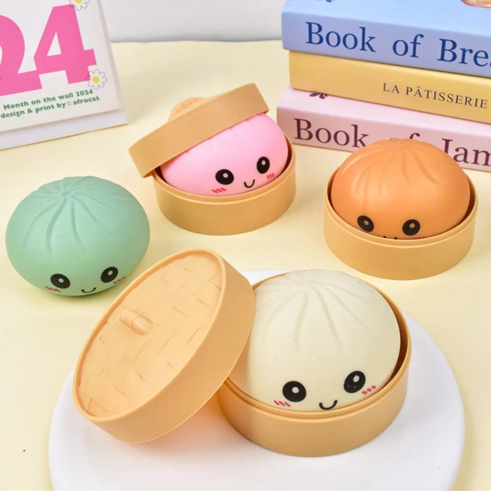 Set of cute, cartoon-style buns in open and closed containers on a light surface.
