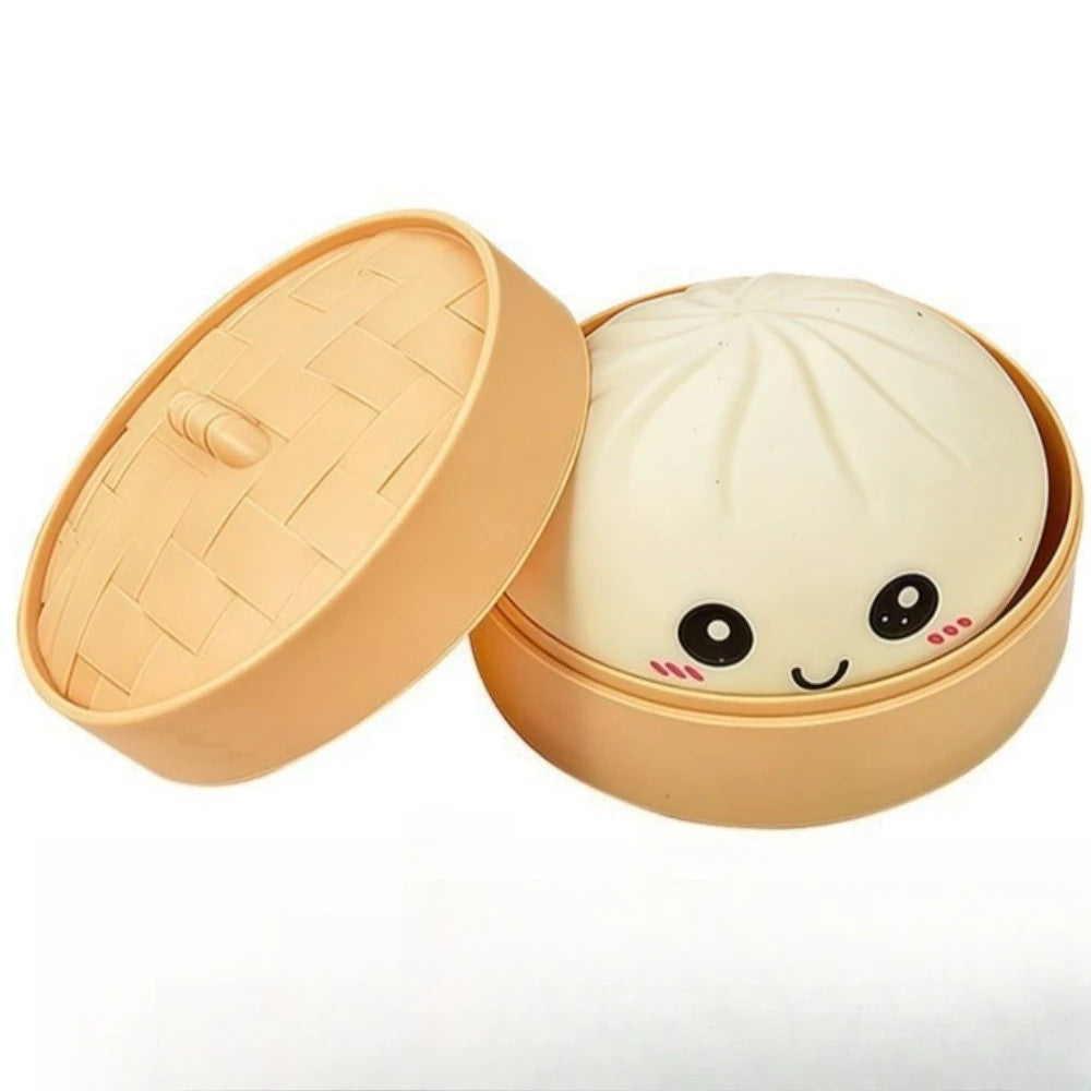 A cute steamer basket-shaped container with a lid that is propped open. Inside, a white dumpling character with a smiling face, black eyes, and pink cheeks is visible.